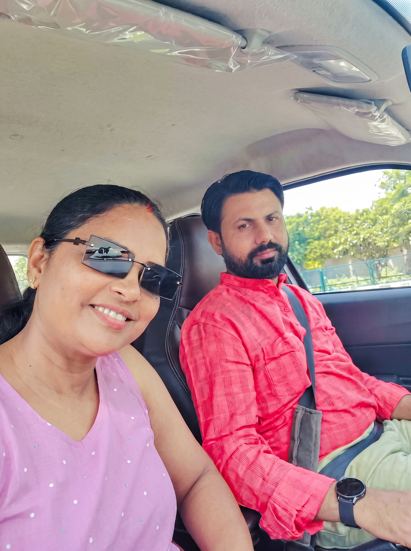 Minakshi Mam smiling on a sunny car journey